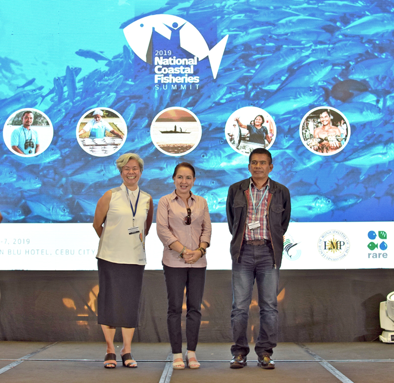 Rare Philippines Vice President Rocky Sanchez Tirona (left) is joined on stage by LMP Mayor Maria Fe Brondial (middle) of Socorro, Oriental Mindoro, and DA-BFAR Undersecretary for Fisheries Eduardo Gongona (right)