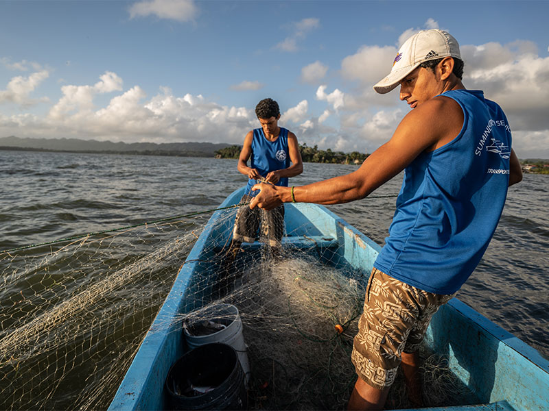 Two fishermen on a boat in Guatemala.