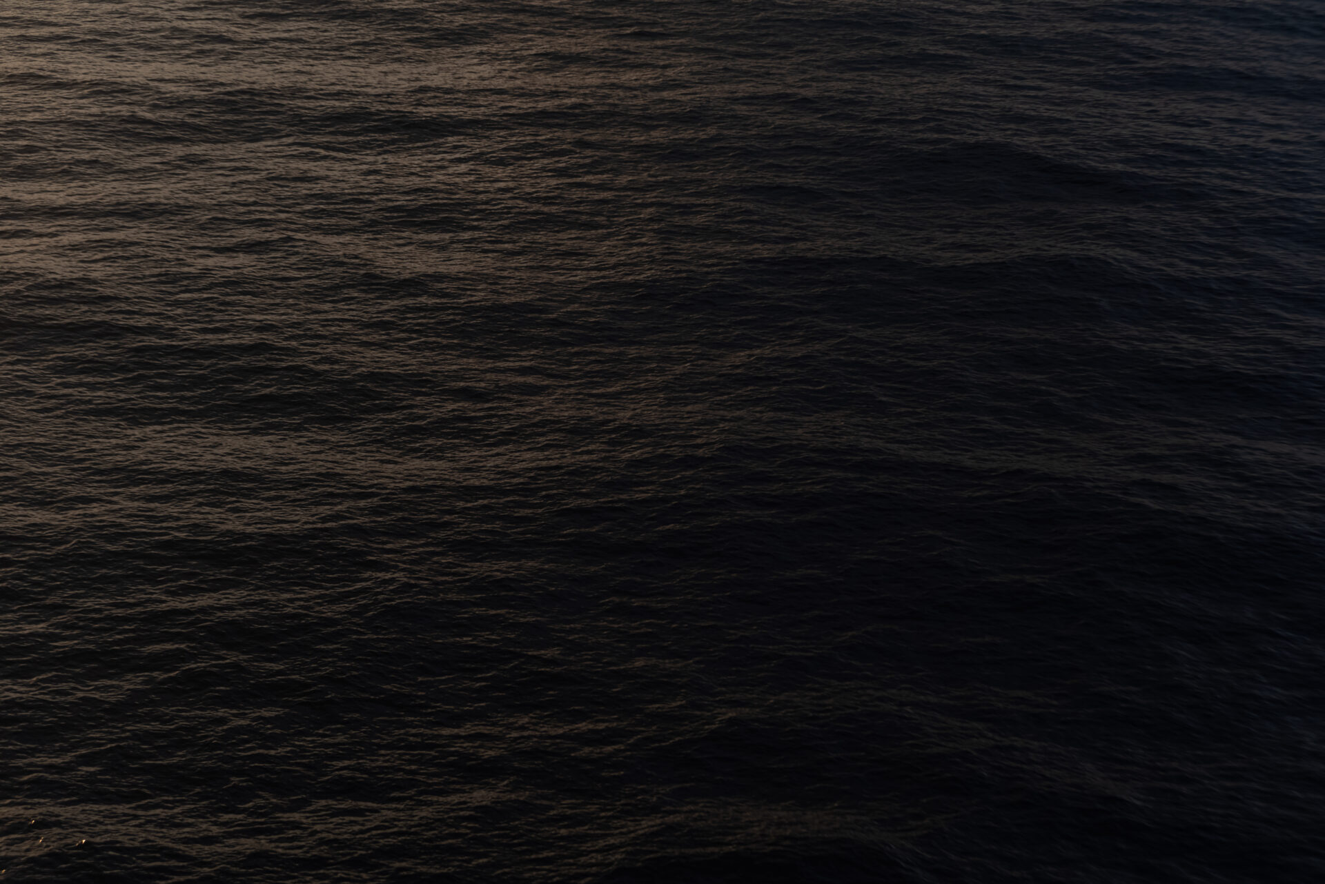 photo of dark, calm ocean waters.
