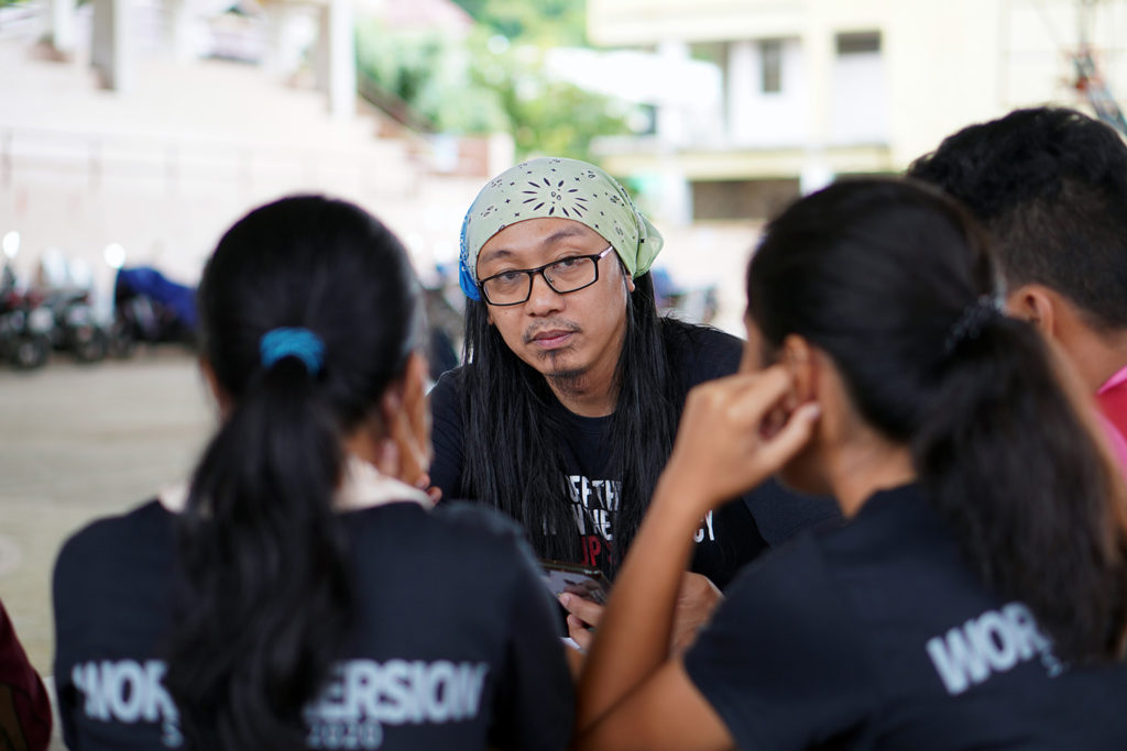 Artist AG Sano with students.