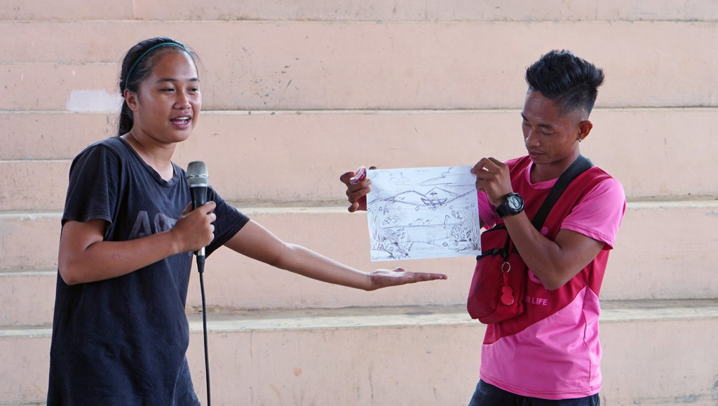 Youth presenting a mural sketch.