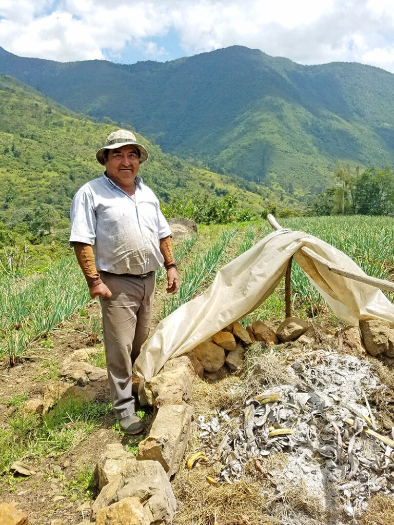 Local farmer, Don José Valencia, and his compost pile in El Moral, Valle del Cauca.