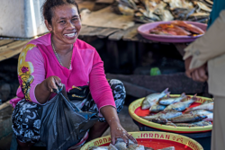 Woman selling fish in a market.