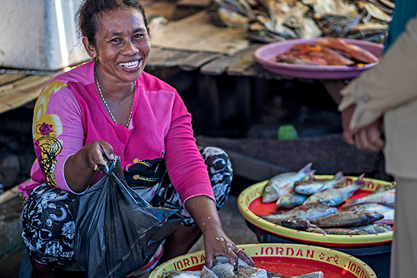 Woman selling fish in a market.