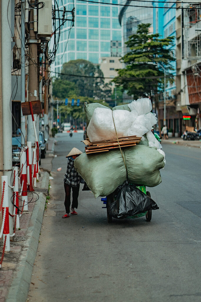 Man pushing a cart in the streets of Ho Chi Minh City, Vietnam.