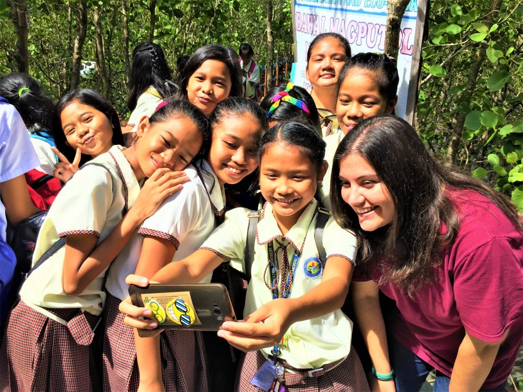 Holly Ziemer and Grade 7 students in Calapan in Oriental Mindoro during Environmental Awareness Time (EAT), which aims to educate over 500 students about the importance of ecosystem stewardship and sustainable fisheries practices.