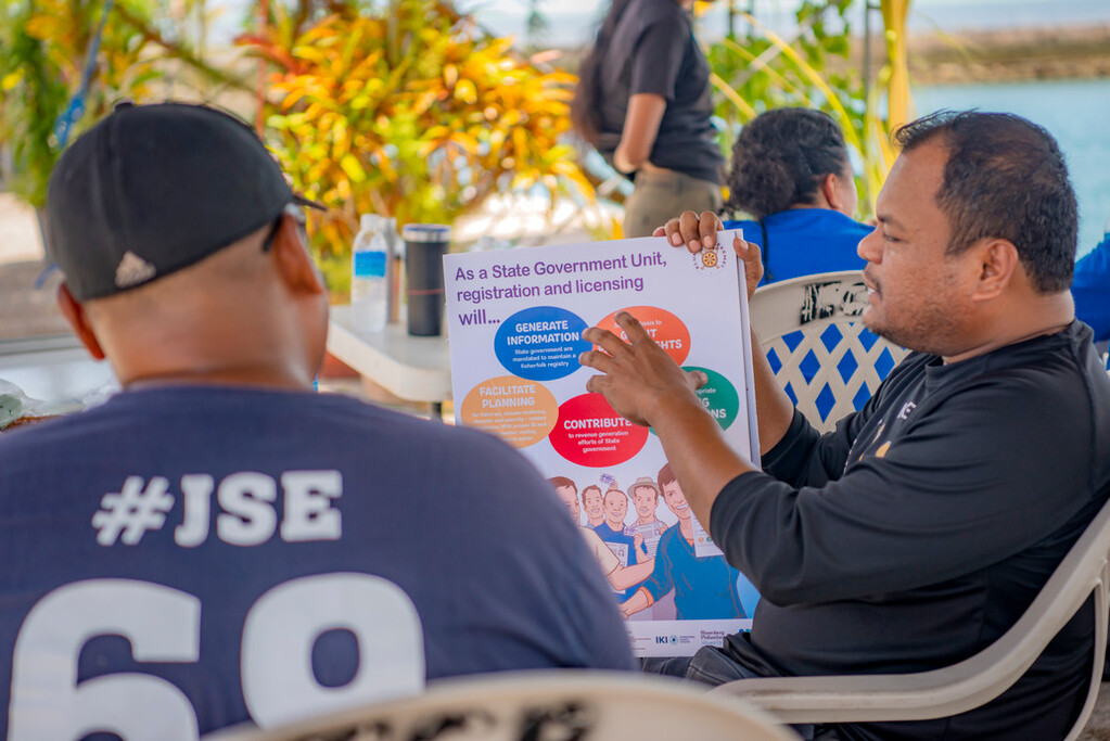 Rare's Kevin Mesebeluu, Program Implementation Manager (PIM) for Palau, speaking with local fishers about fisher registration.