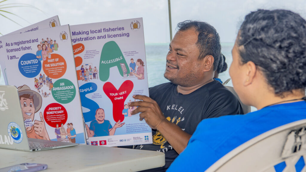 Man holding a fisher registration brochure in Palau.