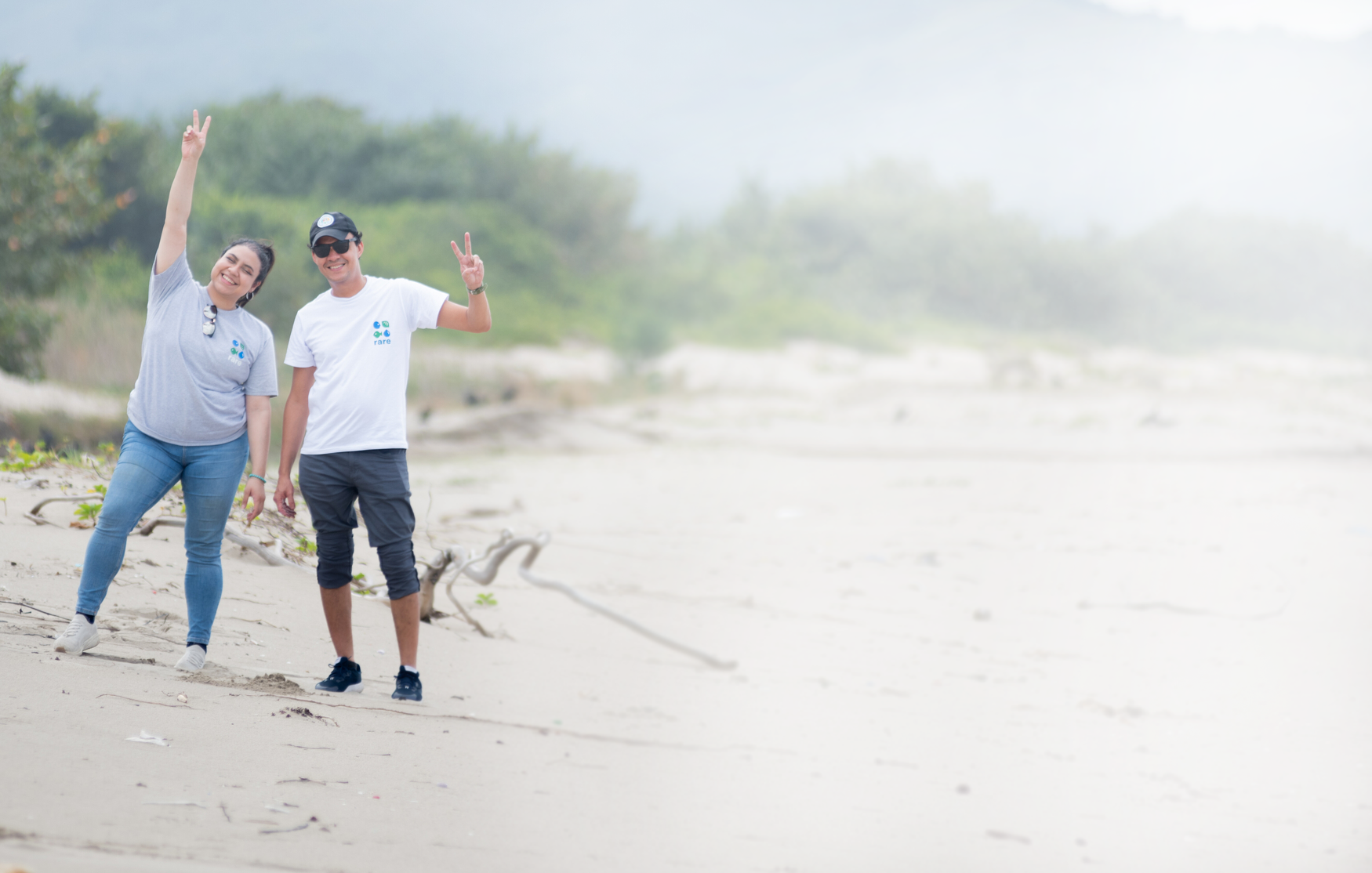 Vicky and Emilio wearing Rare t-shirts on a beach in Honduras.