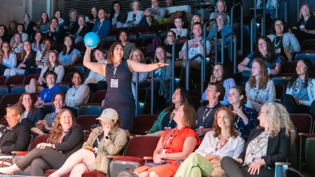 Audience member throwing a ball.