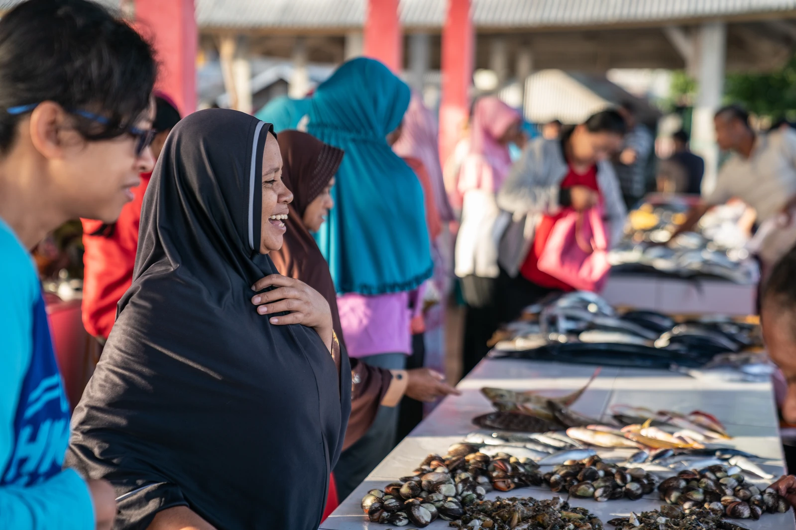 Nurlini (fish buyer and OurFish app user) at the fish market, buying fish for lunch and evening meal.Siompu, Southeast Sulawesi.