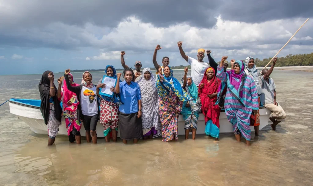 Group of women standing on the shore in Tanzania.