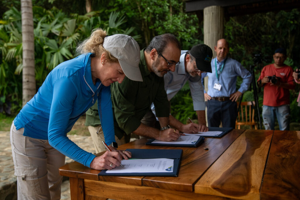 Elizabeth Gray, Audubon's Chief Executive Officer; Sergio Ríos Granados, President of the Development Bank of Latin America and the Caribbean (CAF), and Martin Harper (right), Birdlife International's Chief Executive Officer, sign a memorandum of understanding to invest US$3 billion destined to the sustainable development in Latin America and the Caribbean over the next ten years, at the Botanical Garden of Cali in Cali, Colombia, on October 28, 2024.