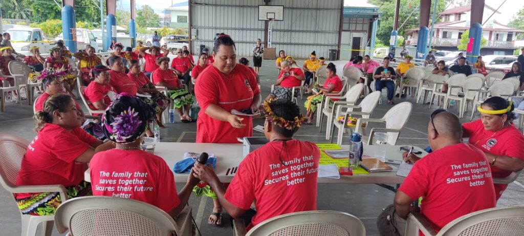 savings club members wearing red shirts around a table