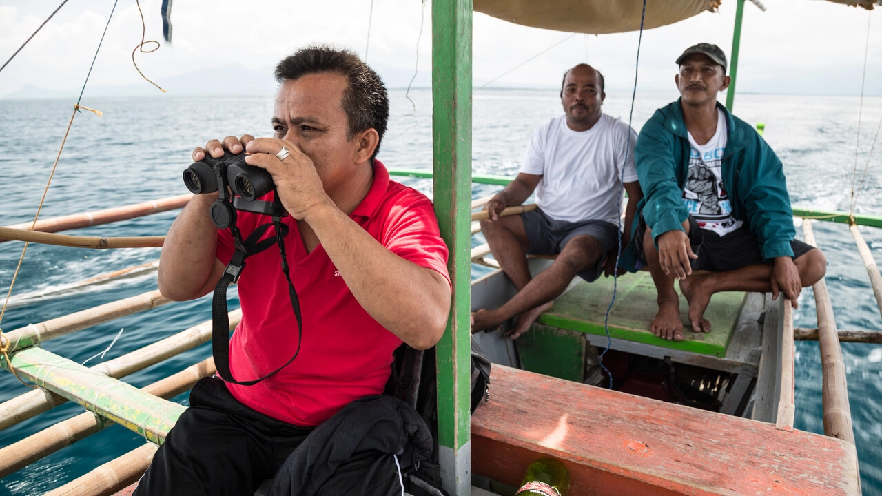 Fishermen on a boat guarding their water.