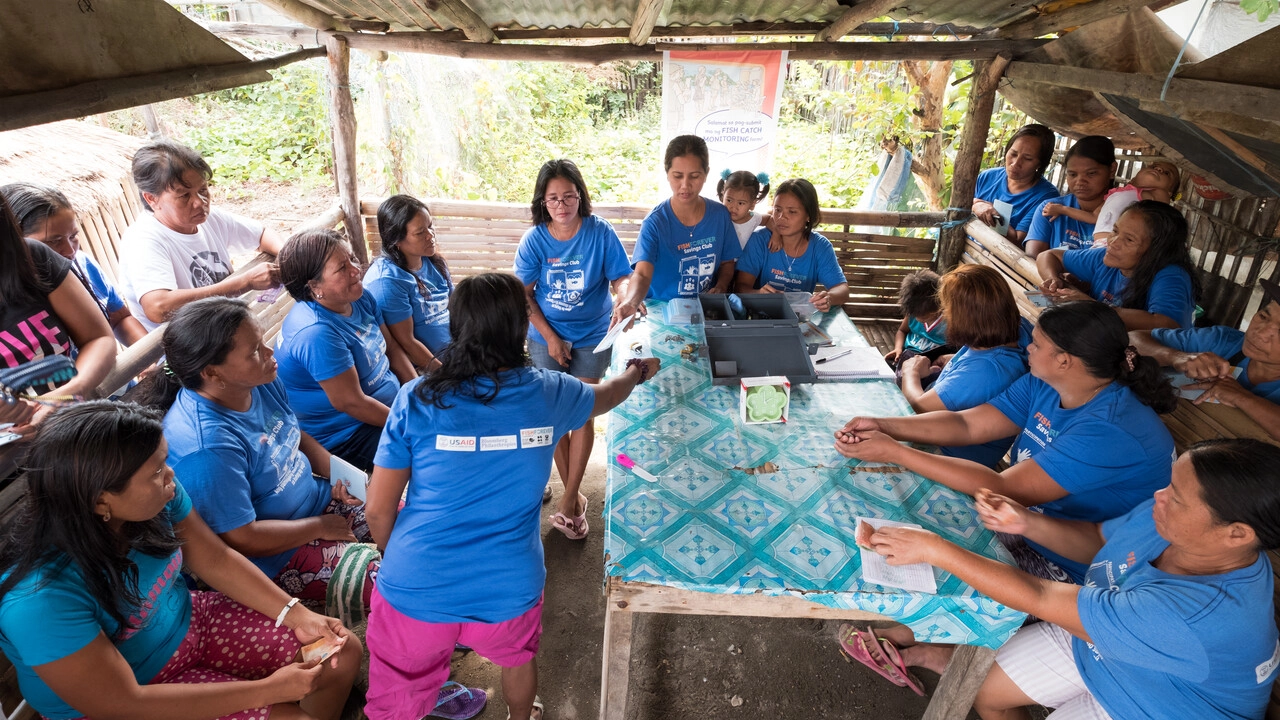 A group of women running a savings club in the Philippines.