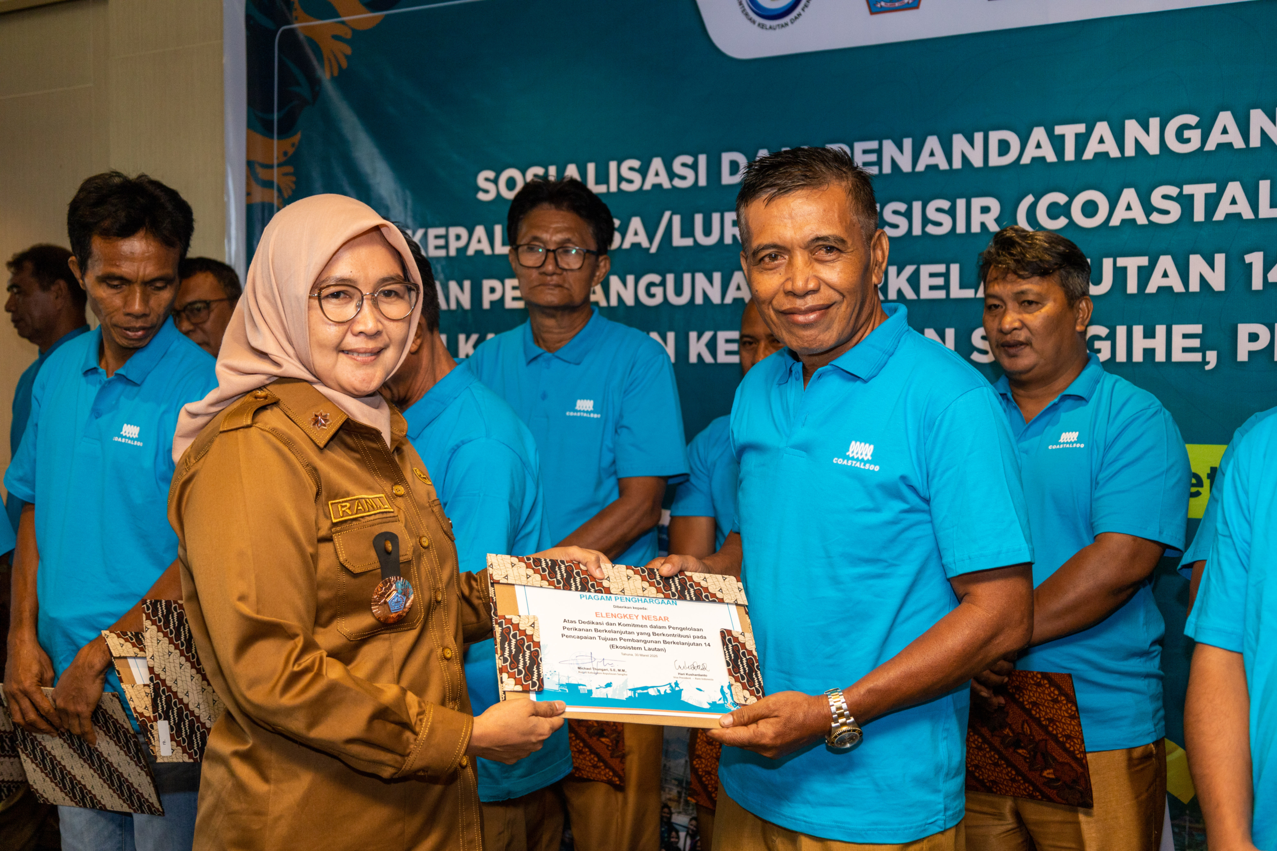 Local leaders receiving the Coastal Award at the pledge event in North Sulawesi, Indonesia. March 2026.