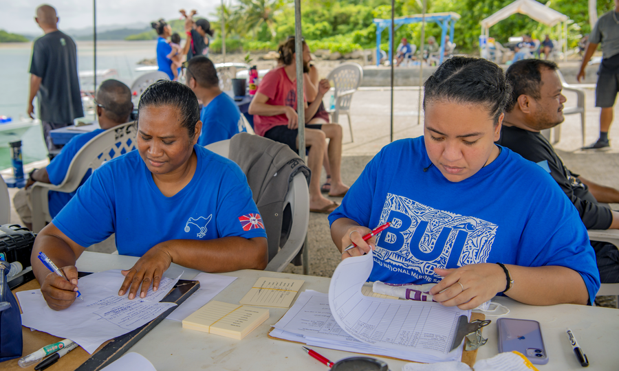 Joy Antonio, MSG PAN Employee, and Kristen Udui, Palau Pledge Media Coordinator, assisting in the registration of fishers for the derby, and conducting survey's on fisher perceptions at a community fishing derby in Melekeok Marina, Palau.