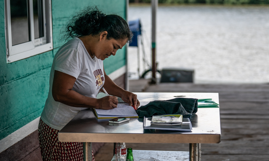 A fish buyer recording catch in Guatemala.