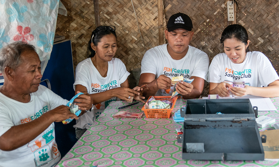 Savings club members counting cash in the Philippines.
